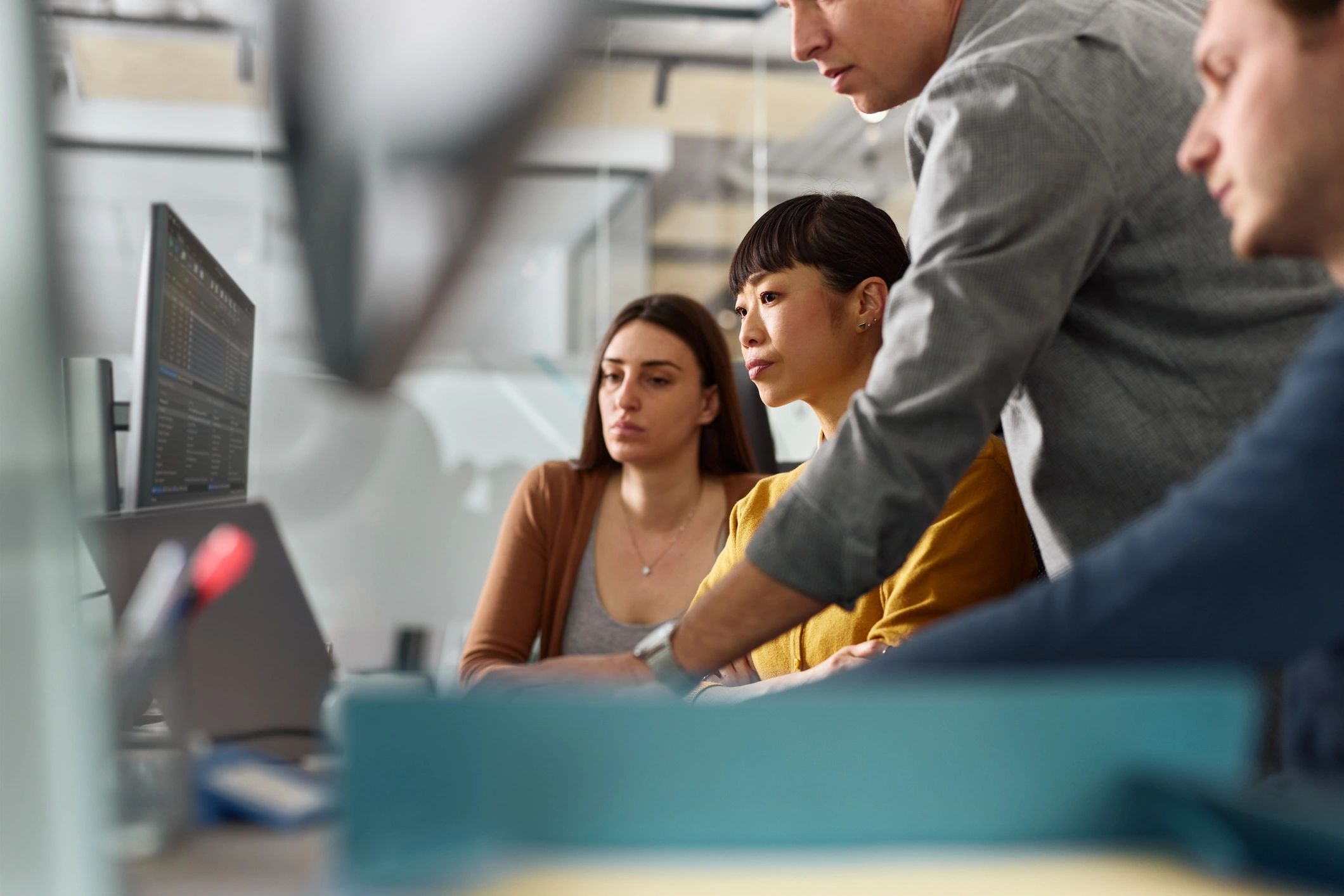 Developers working together at computers in an office